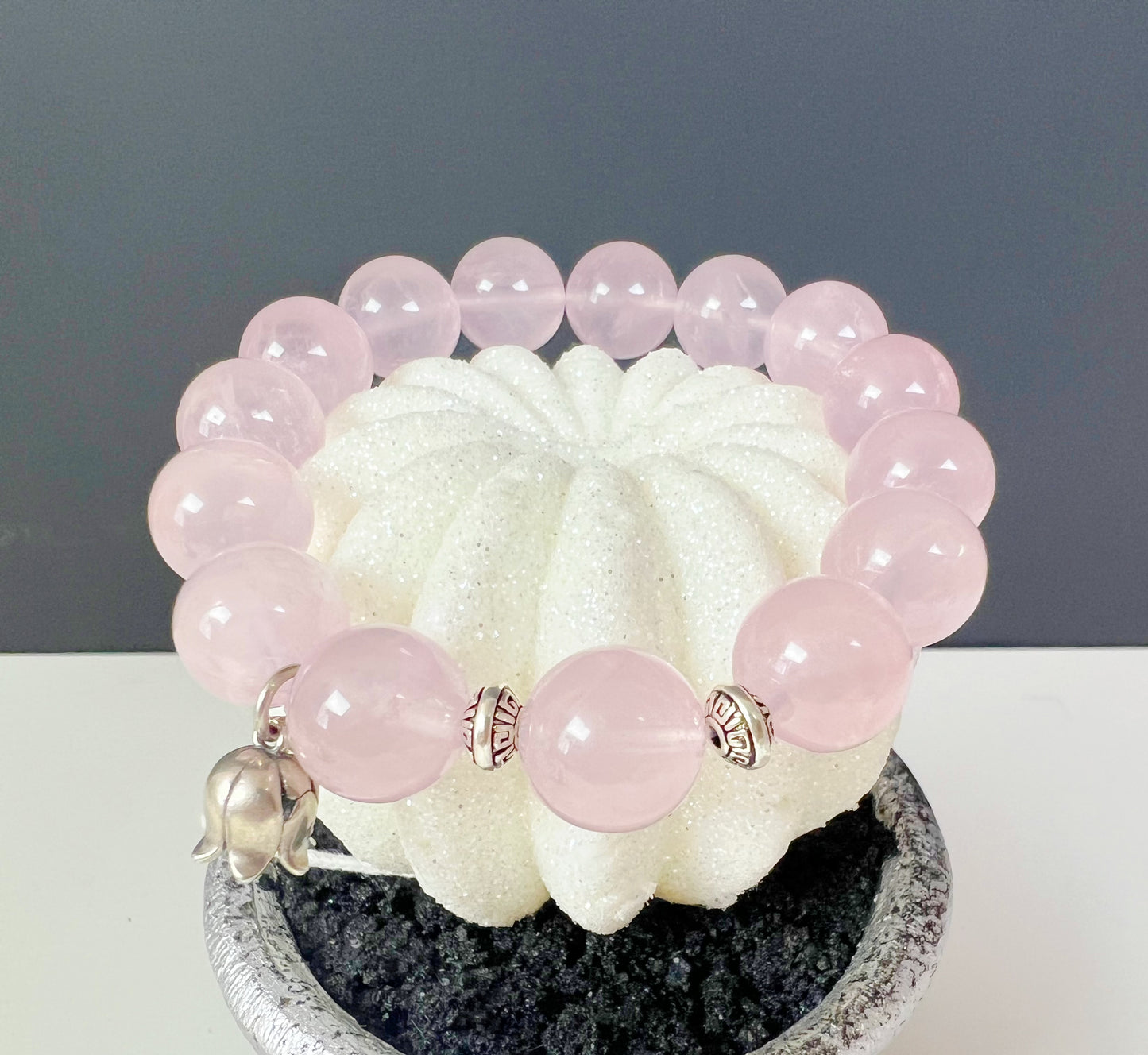 A bracelet made of natural rose quartz and sterling silver accessories